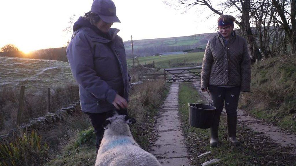 Hannah and mum with sheep