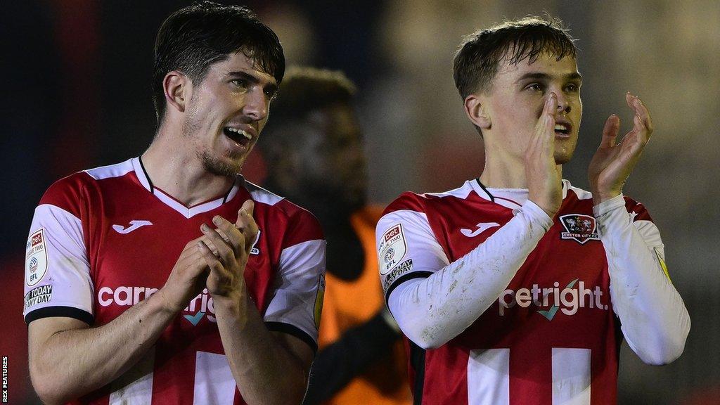 Josh Key (left) and Archie Collins applaud Exeter fans