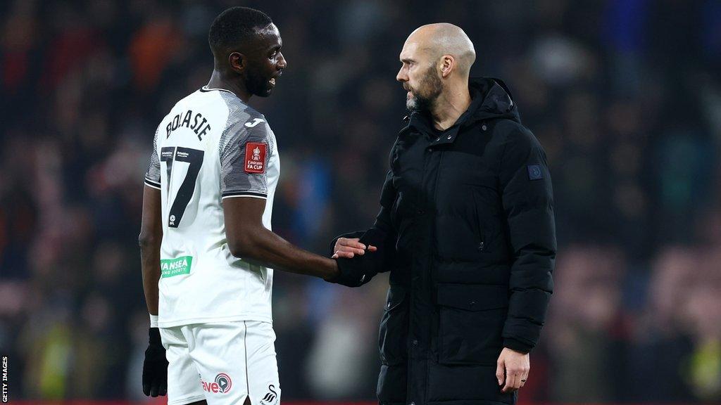 Yannick Bolasie shakes hands with Luke Williams after making his final Swansea appearance in last Thursday's FA Cup loss at Bournemouth