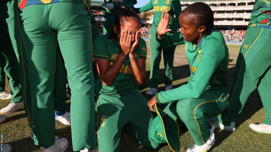 Shabnim Ismail (middle) is in tears surrounded by her team-mates after beating England to reach the T20 World Cup final