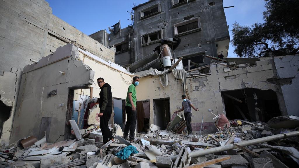 Residents carry out search and rescue efforts after an Israeli attack hits Ebu Al-Rous family building at Tel al-Sultan neighborhood in Rafah