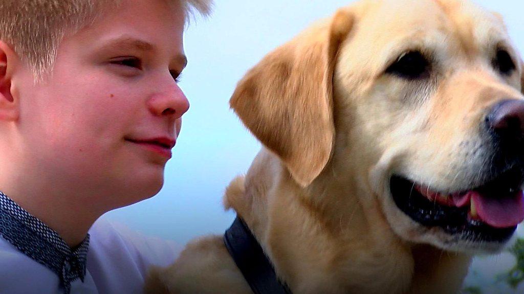 A boy who has combated his autism through his pet dog has raised £30,000 for another assistance dog.