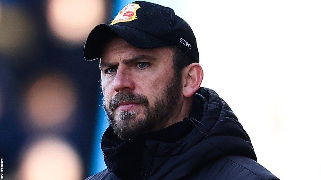 Gavin Gunning looks on from the touchline during a Swindon game