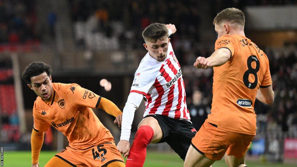 Fabio Carvalho and Greg Docherty of Hull surround Sunderland's Dan Neil