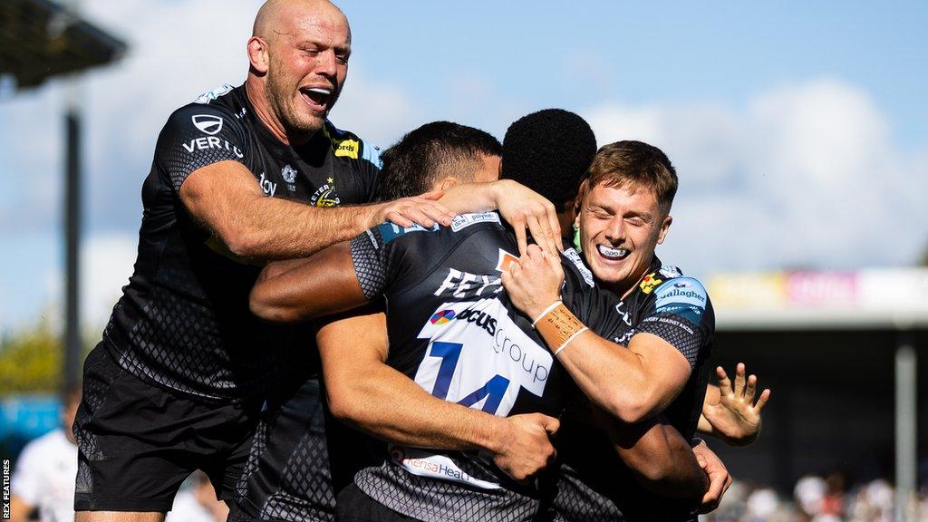 Exeter's players celebrate a try