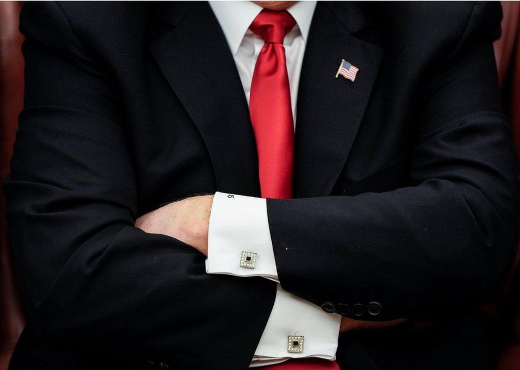 Donald Trump folds his arms