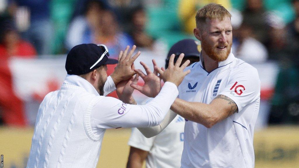 England's Ben Duckett (left) congratulates captain Ben Stokes (right) on taking a wicket