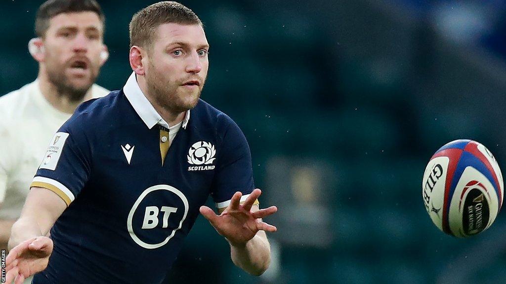 Finn Russell passes the rugby ball