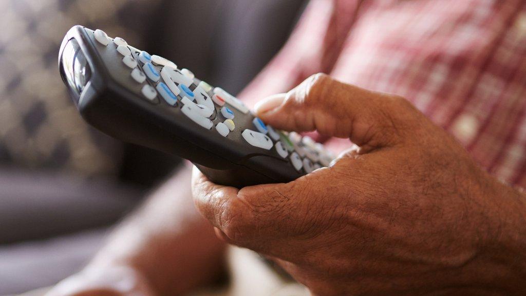 Person holding remote control