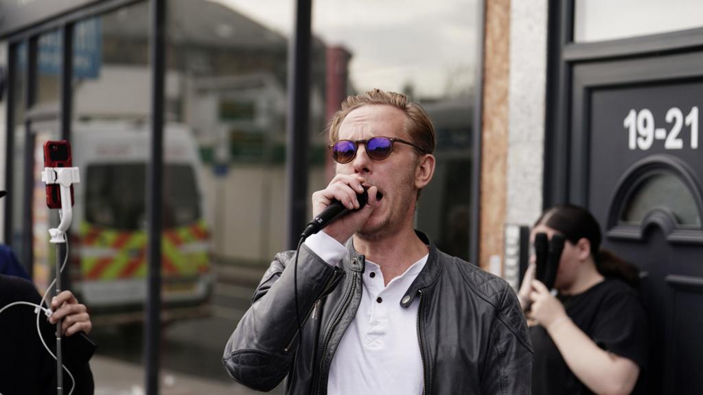 Laurence Fox speaking into microphone