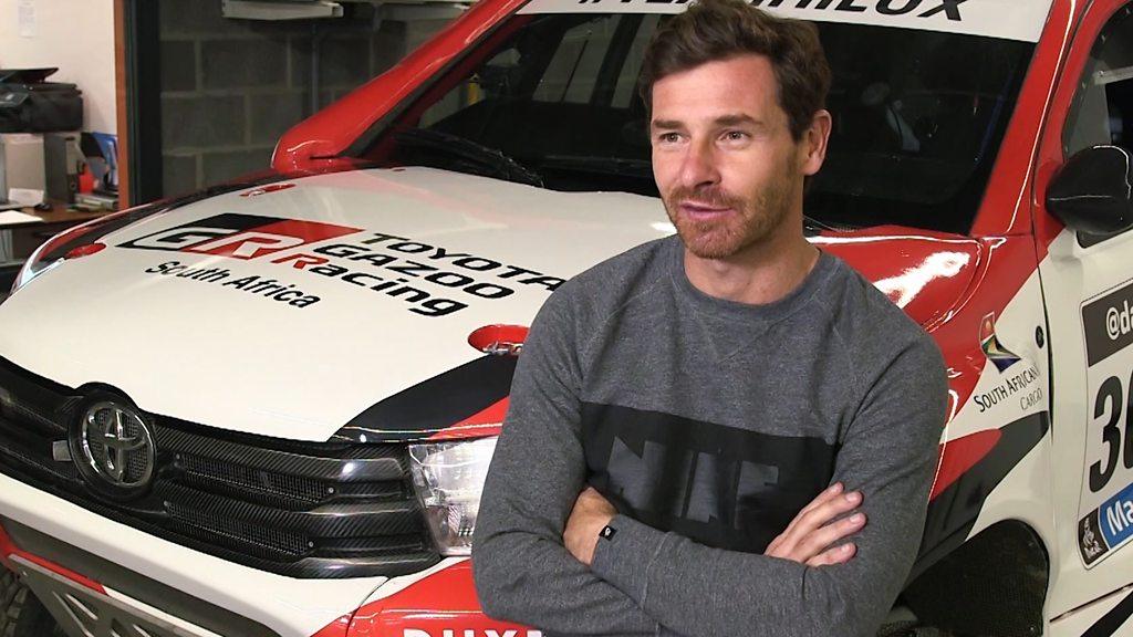 Andre Villas-Boas sat by a rally car