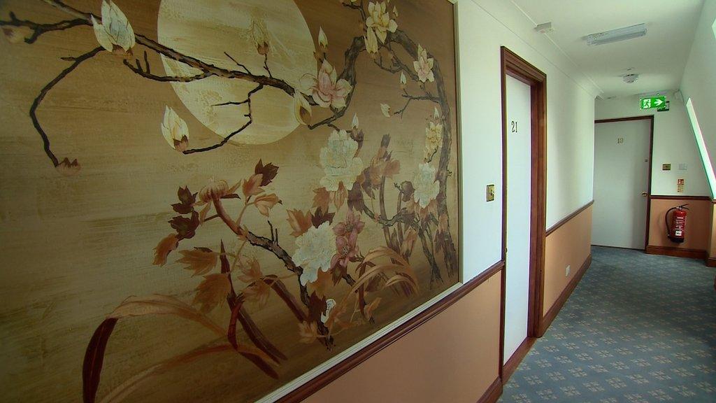 Hallway with artwork and doors