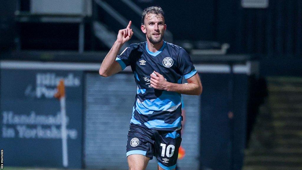 Christian Doidge holds a finger in the air as he runs in celebration after scoring against Bradford