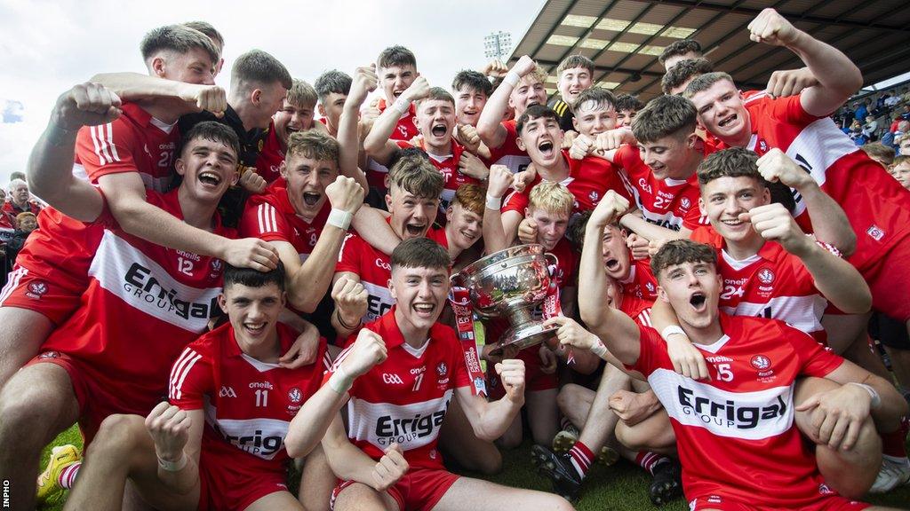 The Derry squad celebrate their win with the Tom Markham Cup