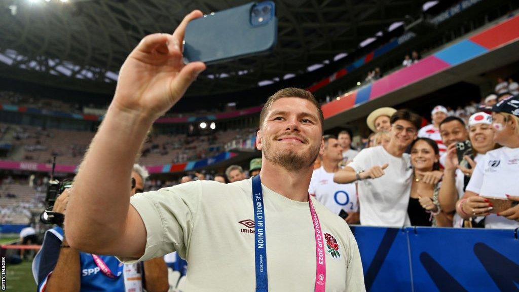 Owen Farrell takes a selfie with England fans at the game aganst Japan