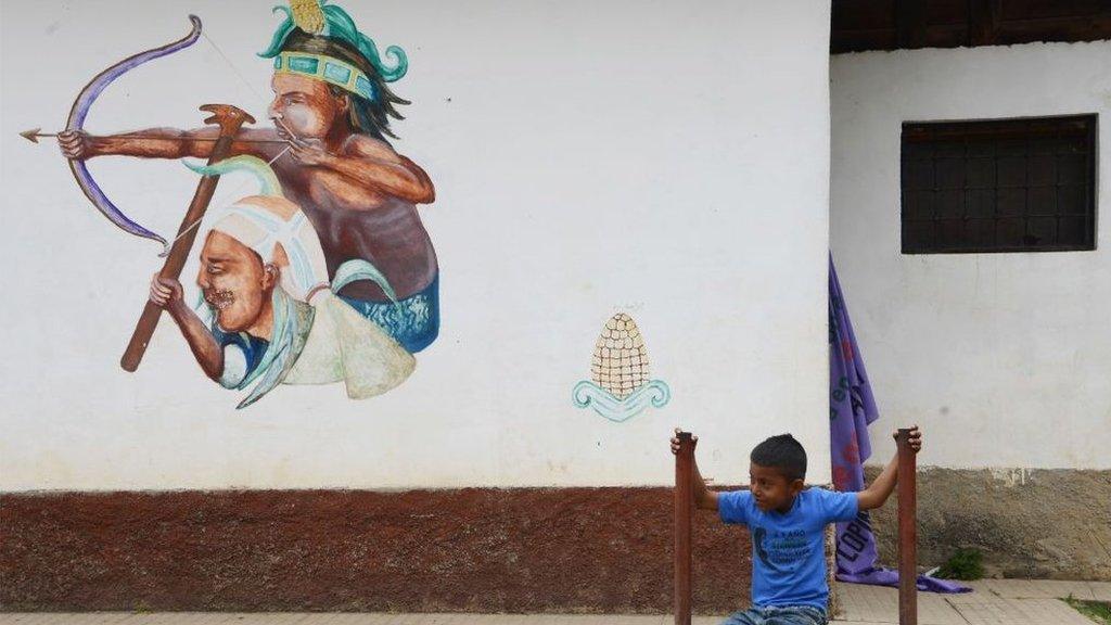 A Lenca indigenous boy sits near the cemetery where indigenous Honduran environmentalist Berta Caceres is buried, on the first anniversary of her murder, in La Esperanza, 180 km west of Tegucigalpa, on March 3, 2017