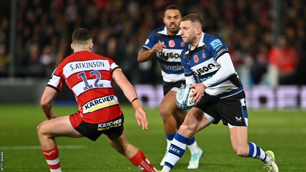 Finn Russell runs with the ball for Bath during their win against Gloucester