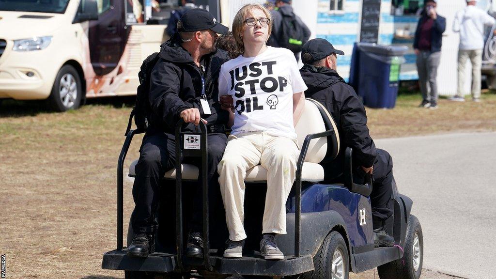 A protester is escorted away by police