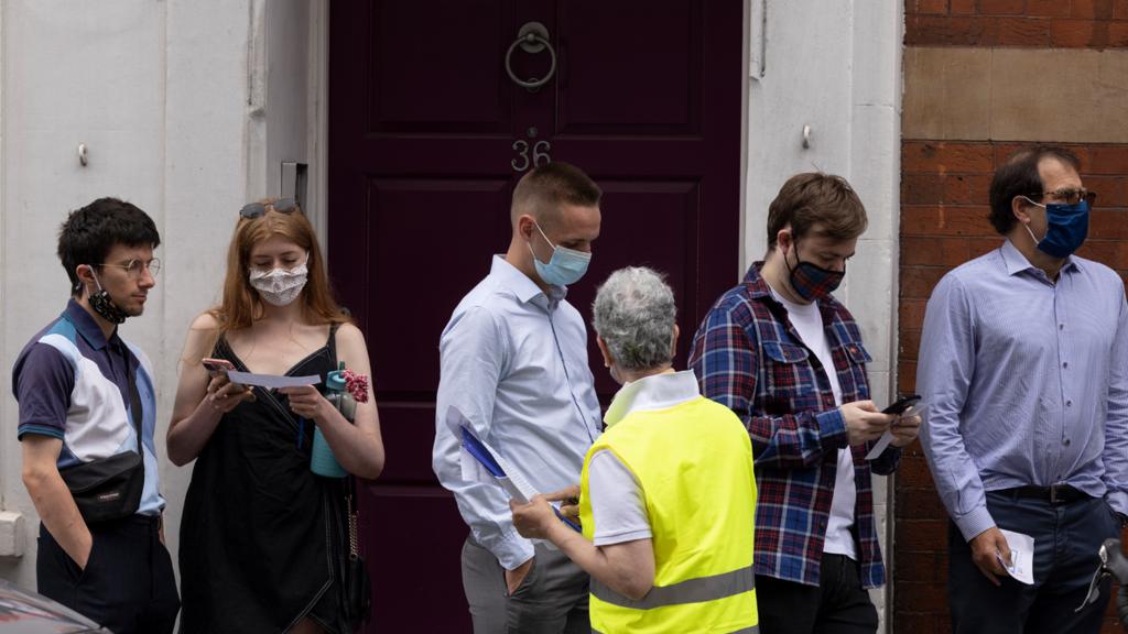 People queue for a walk-in jab centre in Westminster, London