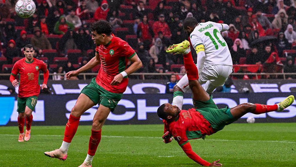 Morocco's Ayoub El Kaabi (right) scores against Comoros