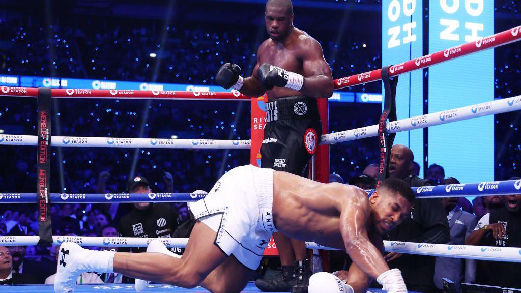 Anthony Joshua hits the canvas with Daniel Dubois over him