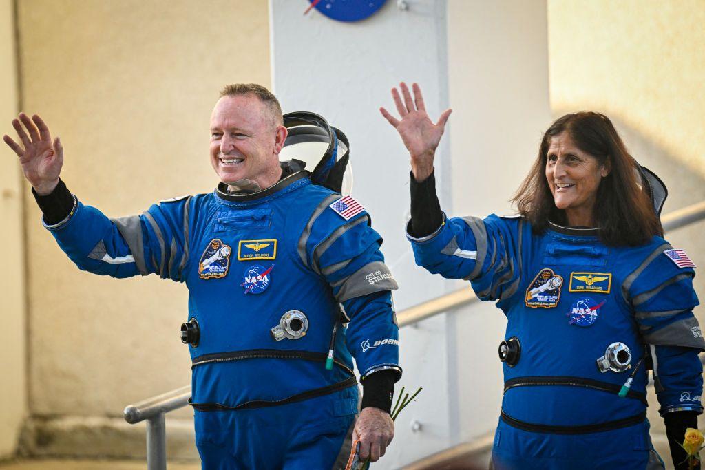 Astronauts Suni Williams and Butch Wilmore waveas they prepare to depart  at Kennedy Space Center 