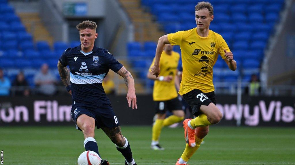 Haverfordwest's Kai Whitmore (left) moves clear of chasing B36 Torshavn's Andrass Johansen