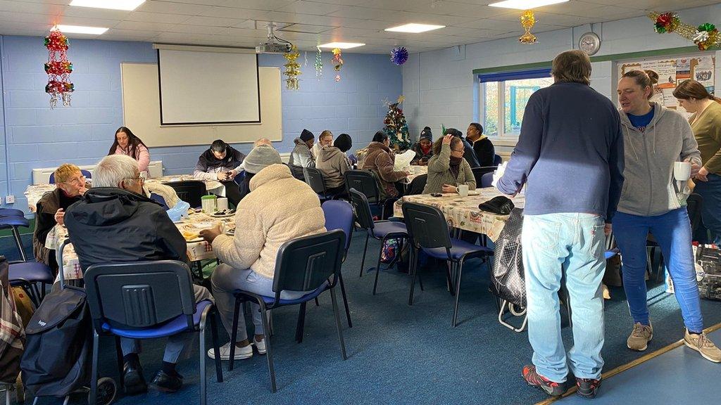 People sat at tables in the community cafe