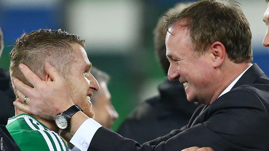 Steven Davis and Michael O'Neill celebrate after Northern Ireland sealed qualification for the Euro 2016 finals