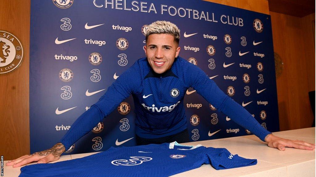 Enzo Fernandez posing with a Chelsea shirt after his £107m move from Benfica