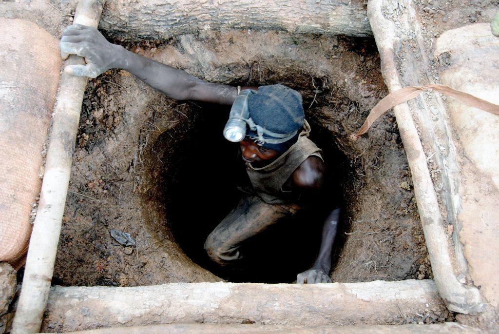 A gold panner, with a torch tied to his head, comes out of an underground mine at an artisanal gold mining site in Sadiola in north-western Mali (archive photo)