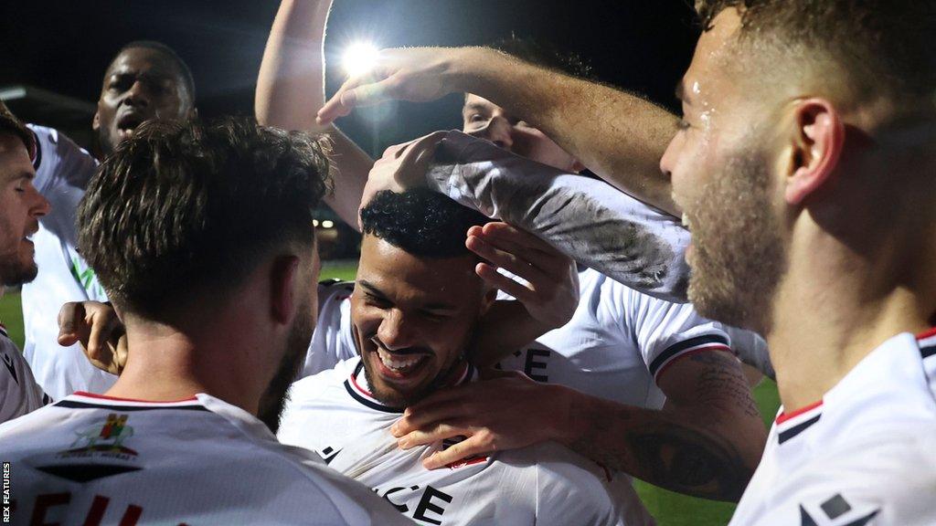 Bolton players celebrate with goalscorer Elias Kachunga