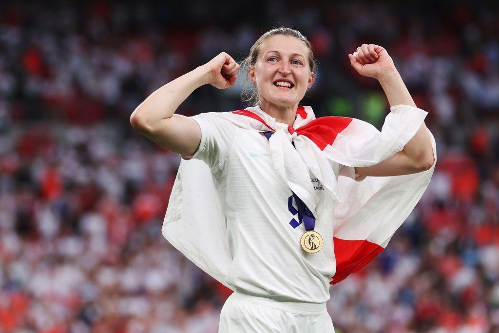 Ellen White seen with England flag around her shoulders and a medal round her neck after 2022 Euros final 
