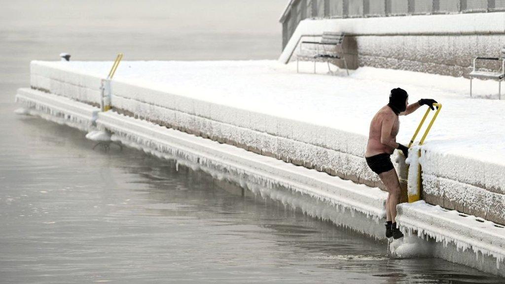 A man gets out from a swim in Helsinki, Finland, in weather of -15C.