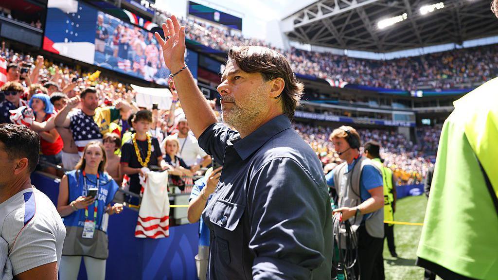Mauricio Pochettino waves to fans after a recent game