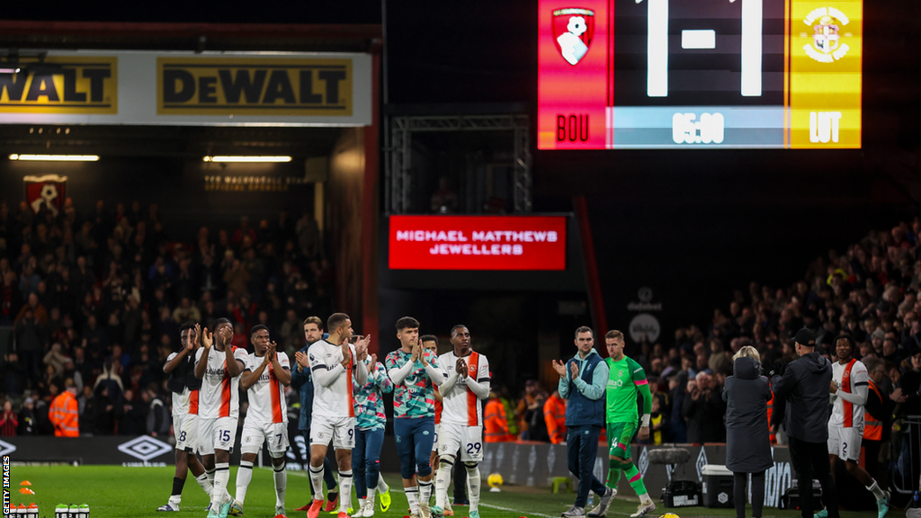 Luton's players applaud the crowd after their match at Bournemouth is abandoned after their captain Tom Lockyer collapsed on the pitch