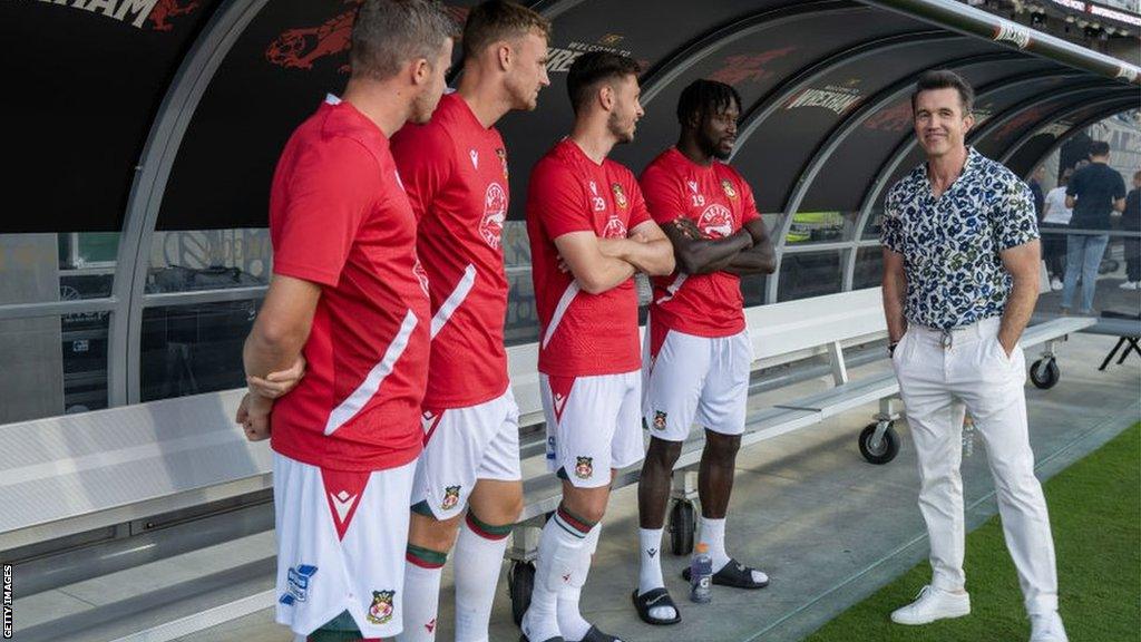 Wrexham co-owner Rob McElhenney speaks to players before the match