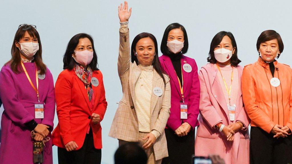 Candidates from the Election Committee constituency wave onstage after winning