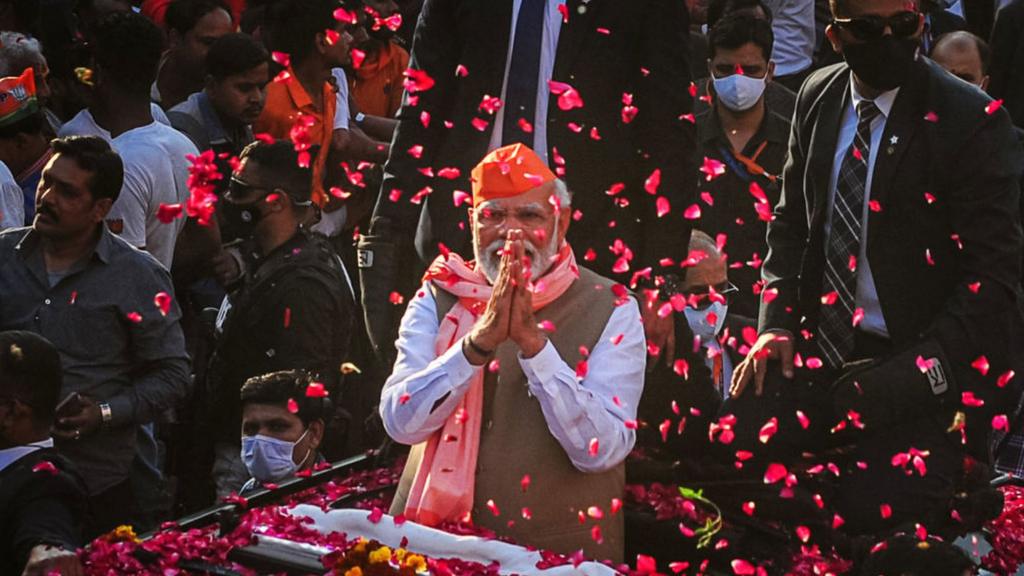 India's Prime Minister Narendra Modi greets crowds of supporters during a roadshow in support of state elections on March 04, 2022 in Varanasi, India.