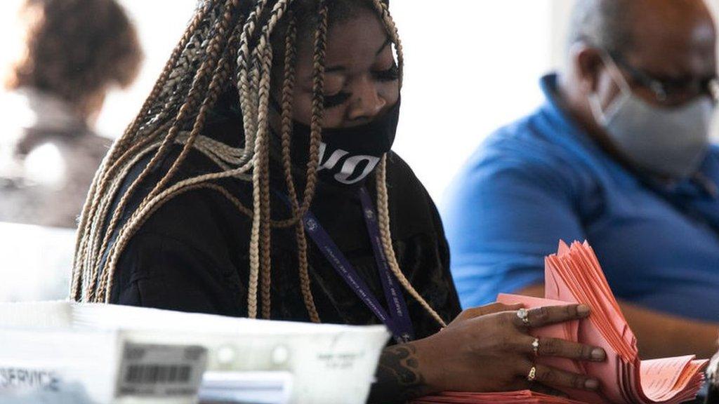 A Fulton county worker continue to count absentee ballots at State Farm Arena in Atlanta, Georgia, on 6 November 2020