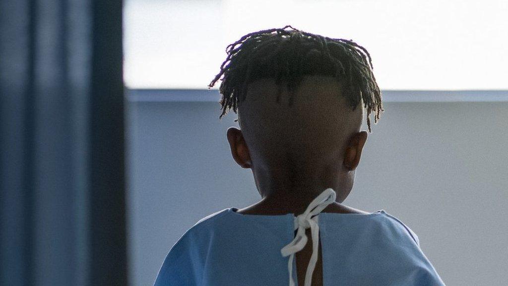 Boy in hospital looking out of window