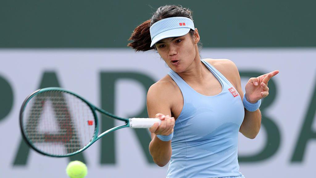 Emma Raducanu plays a forehand shot during a match 