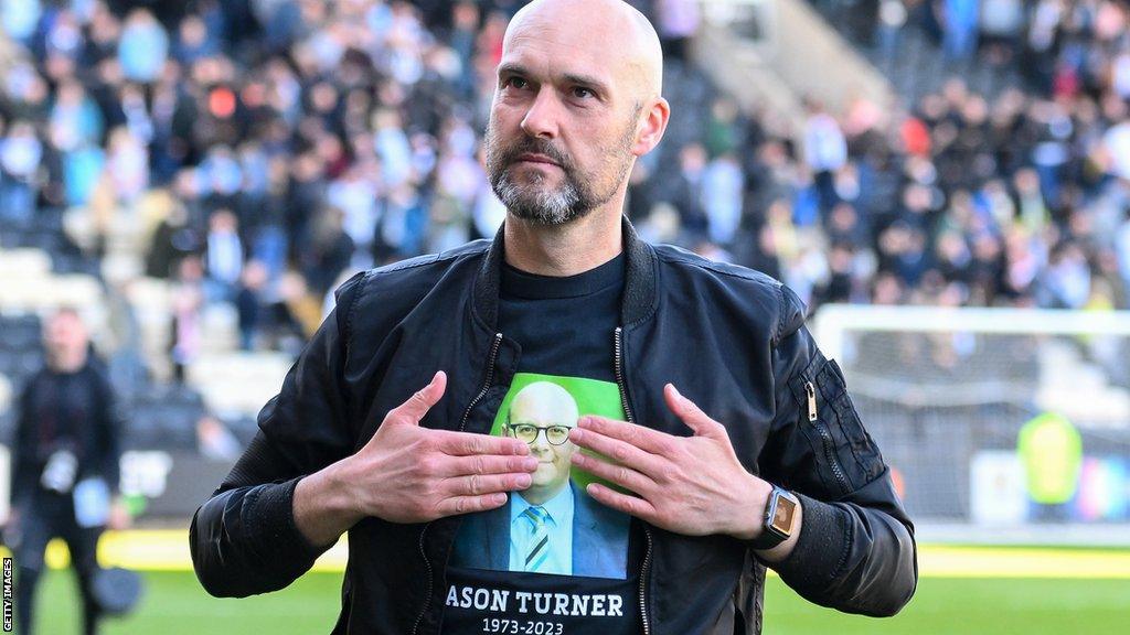 Notts County boss Luke Williams touches his shirt, which was in tribute of the club's late CEO Jason Turner