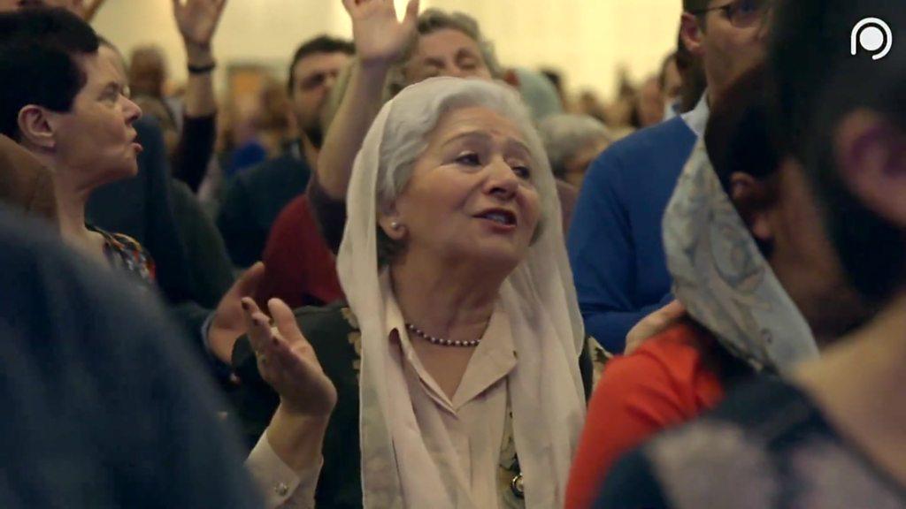 A woman prays during the Mulhouse church gathering.