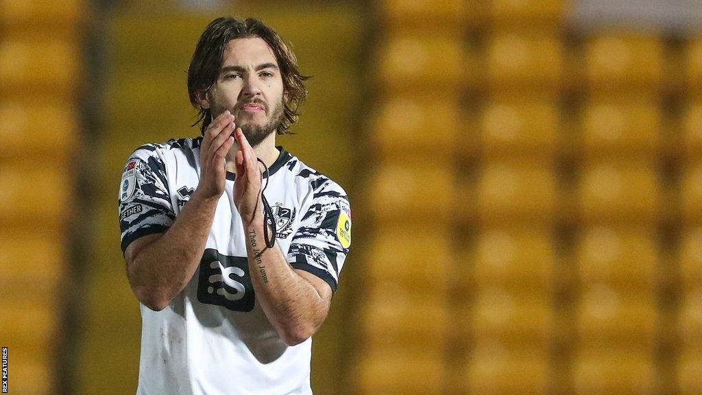 Port Vale defender Dan Jones claps the fans after a match