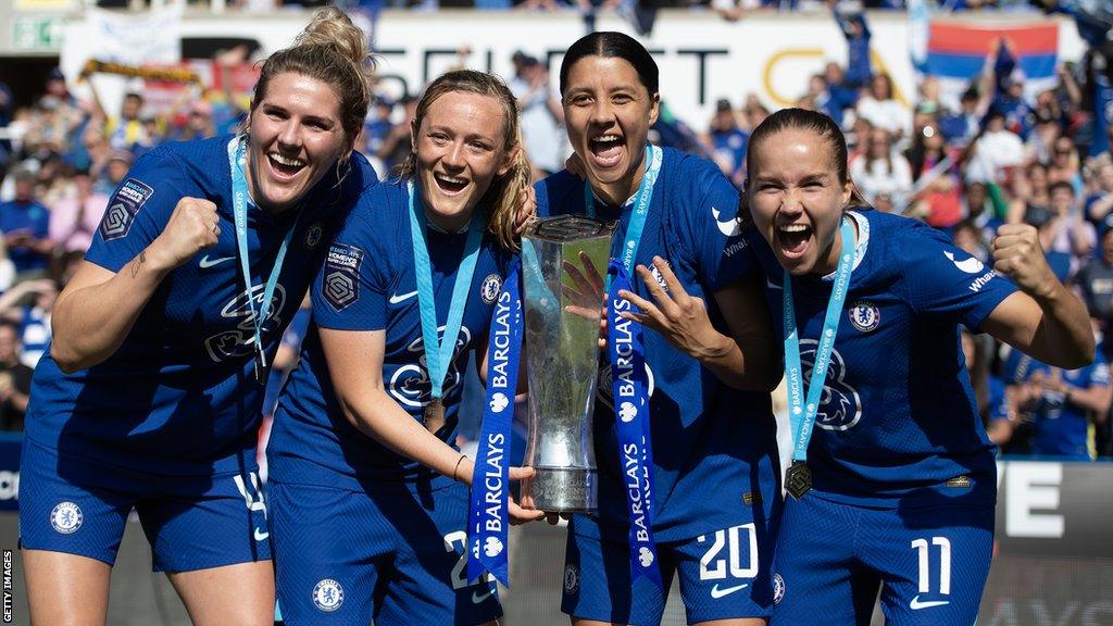 Chelsea players celebrate with the WSL trophy