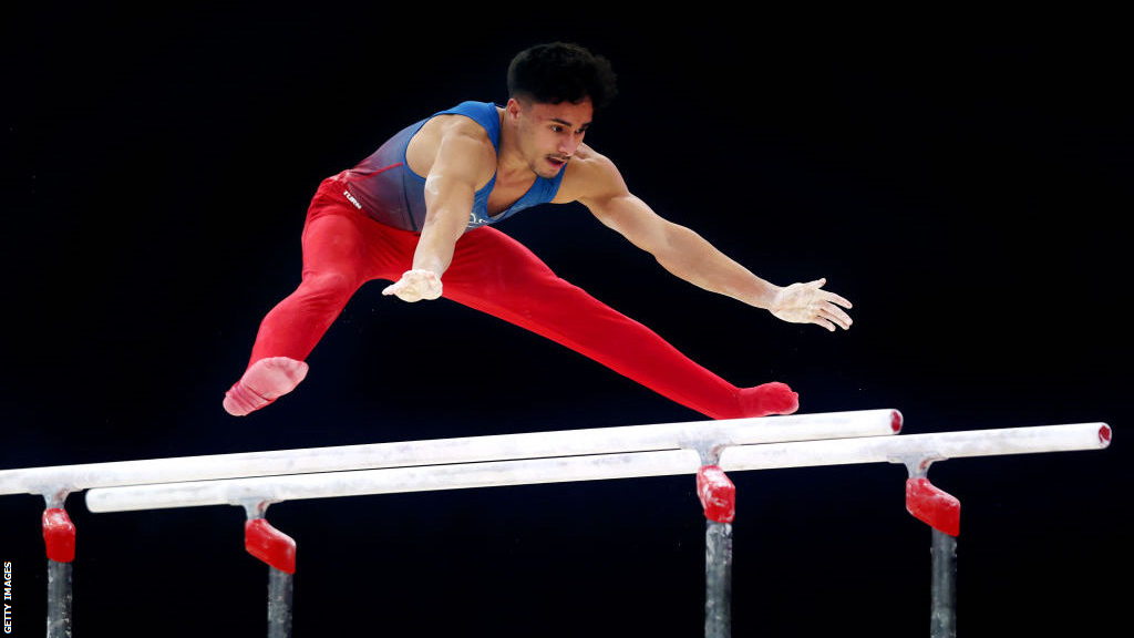 Jake Jarman competing on the parallel bars