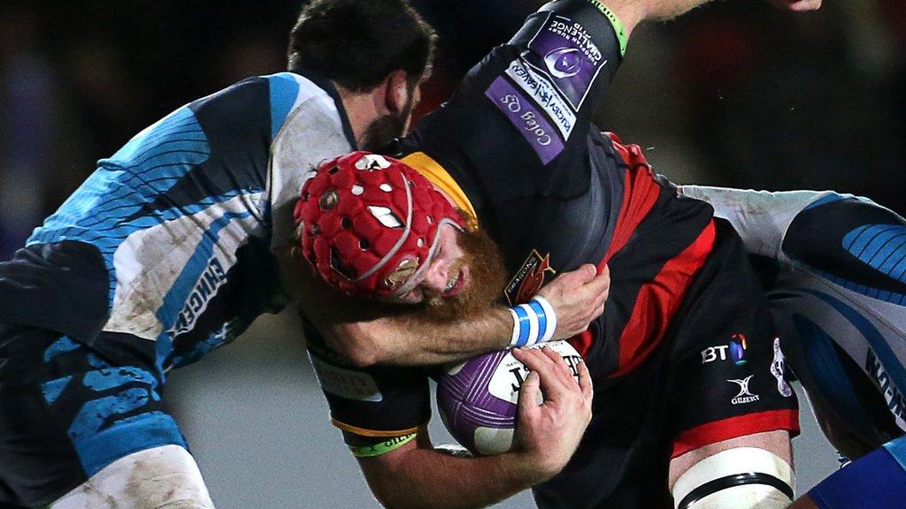 Joe Davies of Dragons is tackled by Vitalii Orlov and Uldis Saulite of Enisei-STM