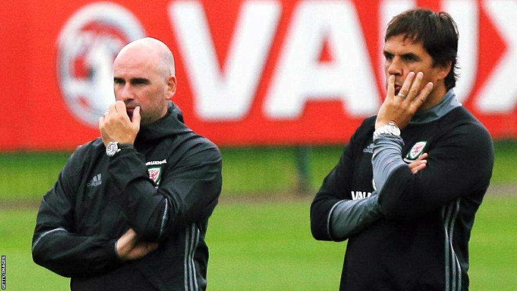 Squad psychologist Ian Mitchell and manager Chris Coleman observe the Wales players during a training session in August 2017