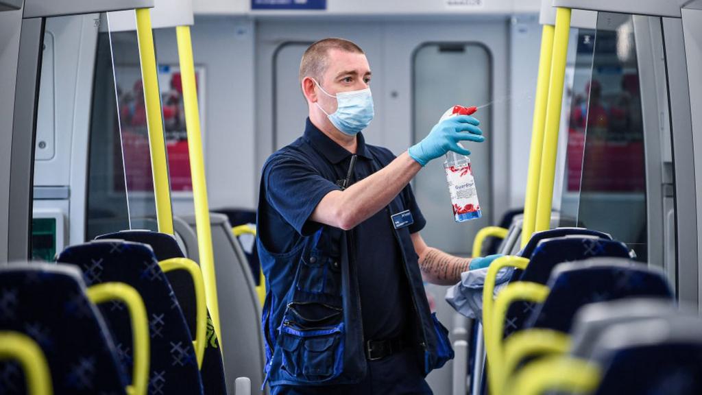 man cleaning train